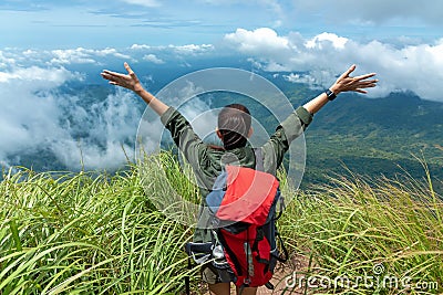 Hiker woman happy feeling freedom good and strong weight victorious facing on the natural mountain. Stock Photo