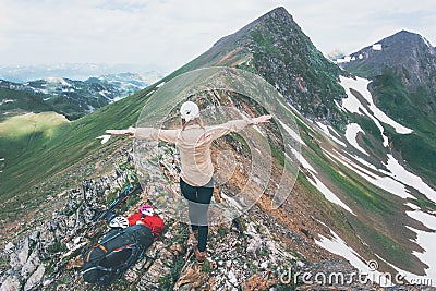 Hiker woman happy hands raised on mountain summit Travel Lifestyle adventure concept summer vacations outdoor exploring wild Stock Photo