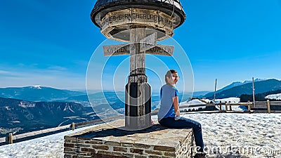 Dreilaendereck - Hiker woman at wooden monument at Dreilaendereck, Karawanks, Carinthia, Austria Stock Photo