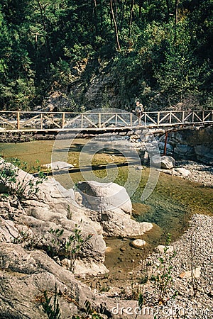 Hiker on the wooden bridge over mountain river in Turkey Stock Photo