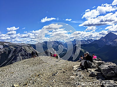 Hikers admiring the glorious view of the Rocky Mountains after completing the Sulphur Skyline Trail Editorial Stock Photo