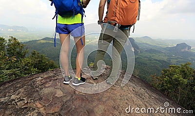 Hikers with backpack enjoy the view on mountain peak Stock Photo