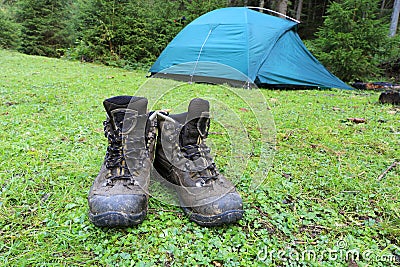 Hikers boots on green meadow Stock Photo