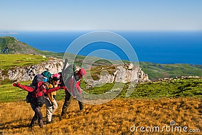 Hikers climbing the mountain Stock Photo