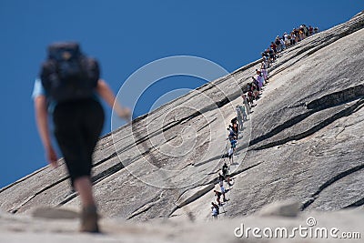 Hikers climbing on a rock Stock Photo