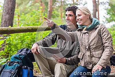 Hikers determinating their position by GPS on tablet PC Stock Photo