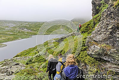 Hikers on the Hydnefossen waterfall Hydna river in Hemsedal, Norway Editorial Stock Photo