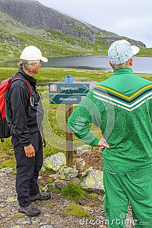 Hikers on the Hydnefossen waterfall make a decision, Hemsedal, Norway Editorial Stock Photo