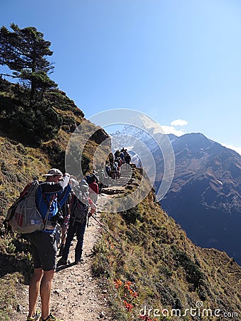 Hikers making their way up busy trail from Namche Bazaar with Thamserku in the background, Sagarmatha National Park, Nepal Editorial Stock Photo