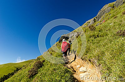 Hikers with red backpack Stock Photo