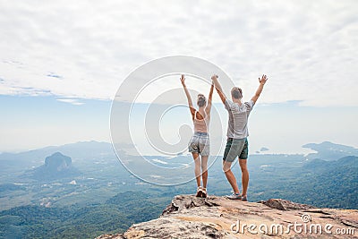 Hikers relaxing on top of a mountain Stock Photo