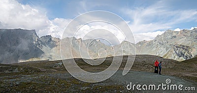 Hikers taking a break in alpine environment surrounded by rocky peaks, Austrian Alps, Europe Editorial Stock Photo