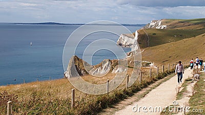 Hikers walking the South West Coast Path in Dorset from Durdle Door to Lulworth Cove Editorial Stock Photo