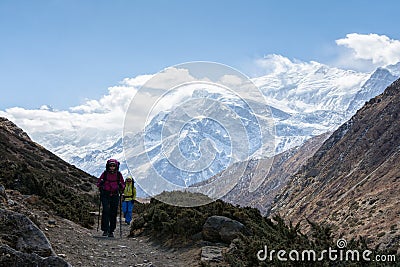 Hikers walking on the trail in Nepal, on Annapurna Circuit Stock Photo