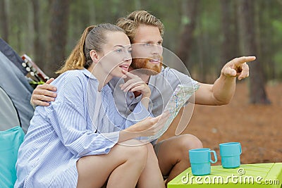 hiking backpacking couple reading map on trip Stock Photo