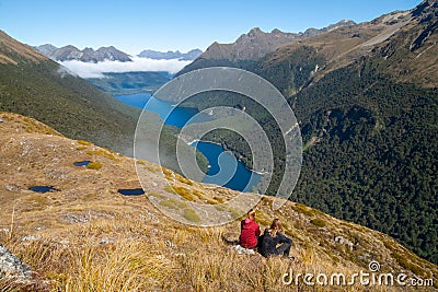 Hiking couple admiring scenic view of lakes Fergus, Lake Gunn and Livingstone mountain range Editorial Stock Photo