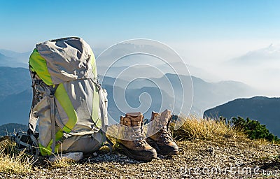 Hiking equipment. Backpack and boots on top of mountain. Stock Photo