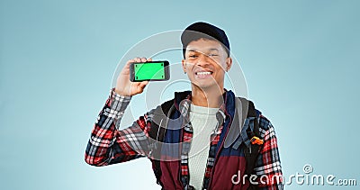 Hiking, green screen and man with a smartphone, portrait and backpack on a blue studio background. Person, hiker and Stock Photo