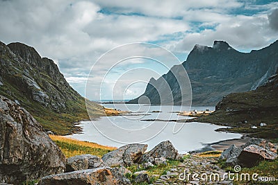 Hiking impressions at Bunes sand beach with view to Bunes Fjorden at Lofoten Islands in Norway on a blue sky with clouds Stock Photo