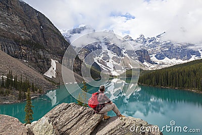 Hiking Man Looking Moraine Lake & Rocky Mountains Stock Photo