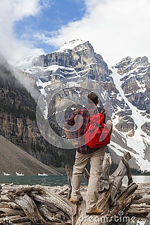 Hiking Man Looking at Moraine Lake & Rocky Mountains Stock Photo