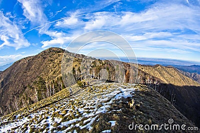 Hiking through mountain landscape in early spring, mount Stolovi Stock Photo