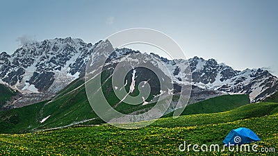 Hiking in mountains. Tent in mountain. Tourist camp in highlands. Trekking in wild mountains Stock Photo