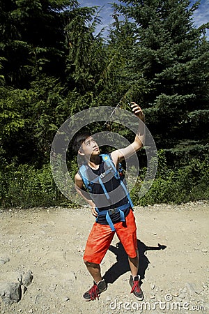 Hiking Selfie with Smartphone by Generation Y Teenager in Forest Stock Photo