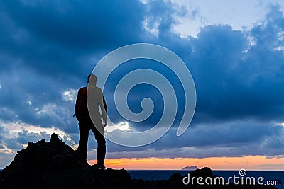 Hiking silhouette backpacker, inspirational sunset landscape Stock Photo