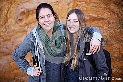 Hiking is their shared passion. Portrait of two attractive young female hikers standing by a rockface. Stock Photo
