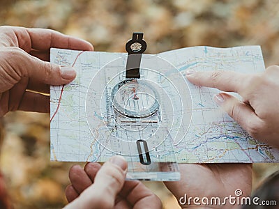 Hiking tourism hobby travelers compass map Stock Photo