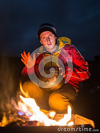 Hiking tourist have a rest in his camp at night Stock Photo