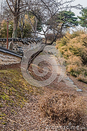 Hiking trail beside mud and stone oriental wall Stock Photo