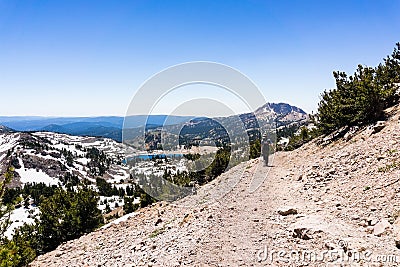 Hiking trail to Lassen Peak, Lake Helen in the background; Lassen Volcanic National Park, Northern California Stock Photo