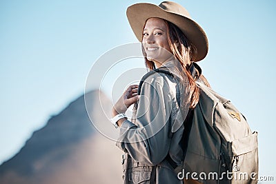 Hiking woman, portrait and smile by mountain, summer or explore with backpack, excited or happy for workout. Hiker girl Stock Photo