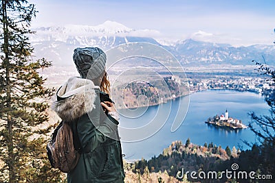 Hiking young woman with alps mountains and alpine lake on background. Stock Photo