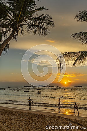 Vertical view with tourist is walking along Turtle Beach during sunset. Hikkaduwa Editorial Stock Photo