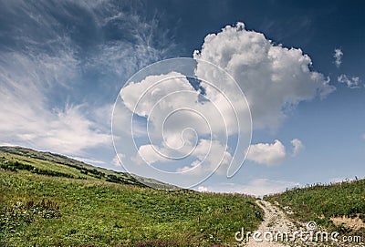 Hill landscape with deep blue sky and big cloud Stock Photo
