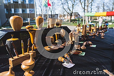 04.18.2023 Hillegom, Netherlands. Various wooden objects placed on a market stall during local Dutch market. Wooden Editorial Stock Photo