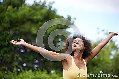 The hills are alive. a carefree and attractive young woman enjoying time in the outdoors. Stock Photo