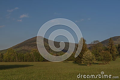 Hills over Trojanovice village in spring sunny color evening Stock Photo