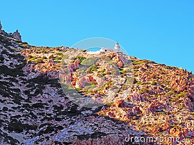 The lighthouse of Polyaigos, an island of the Greek Cyclades Stock Photo