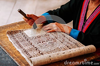 Hilltribe woman hand do Batik fabric painting Stock Photo