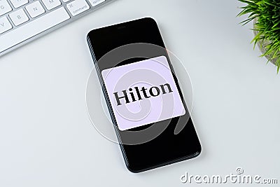 Hilton Honors app logo on a smartphone screen. Editorial Stock Photo