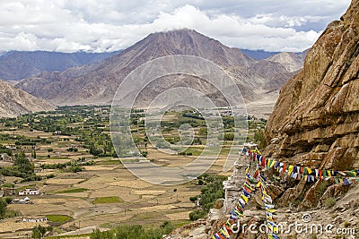 Himalayan mountains and colorful Buddhist prayer flags on the stupa near Buddhist monastery in Ladakh, India Stock Photo