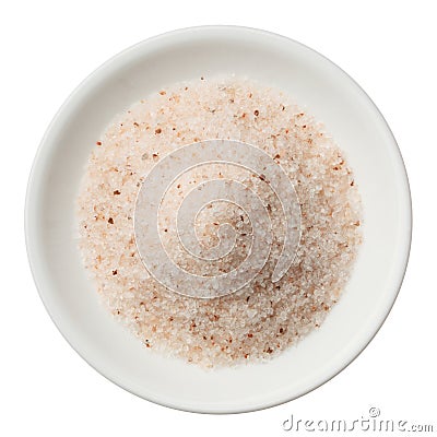 Himalayan pink salt pile in a plate isolated on white top view Stock Photo