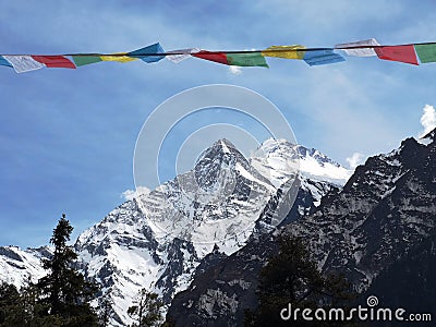 Himalayan prayer flags and mountains up in front Stock Photo