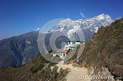 Himalayas mountains landscape with trail to guest house hidden half behind green hill Stock Photo