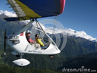 HIMALAYAS, POKHARA, NEPAL. 28 September 2008: Foreign tourist flying on a hang glider deltaplan. Editorial Stock Photo