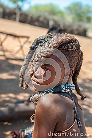 Himba girl with traditional hair locks posing for photographers Editorial Stock Photo